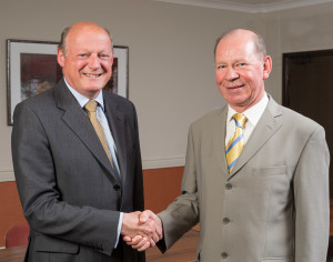 Robert Flather (left) shakes hands with outgoing chairman Bob Usher